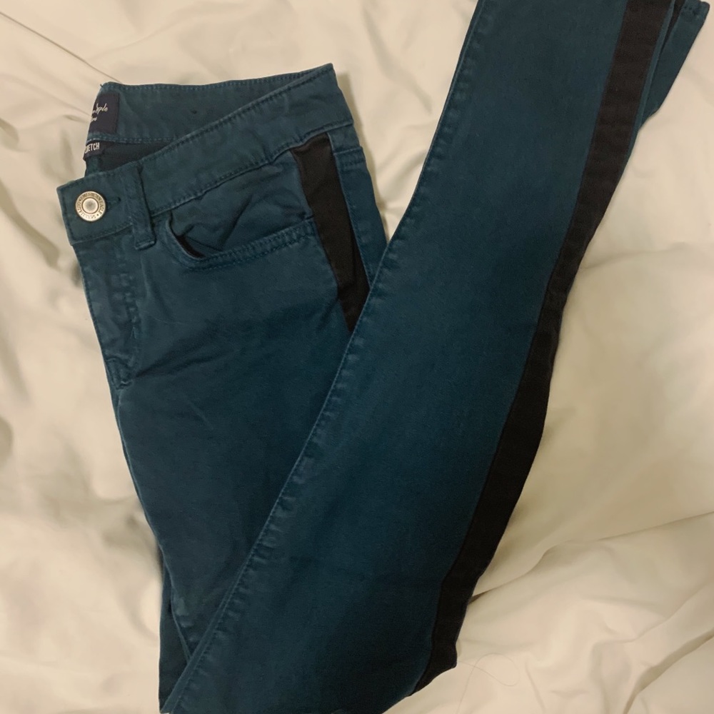 Greenish-blue jeans with black stripe
